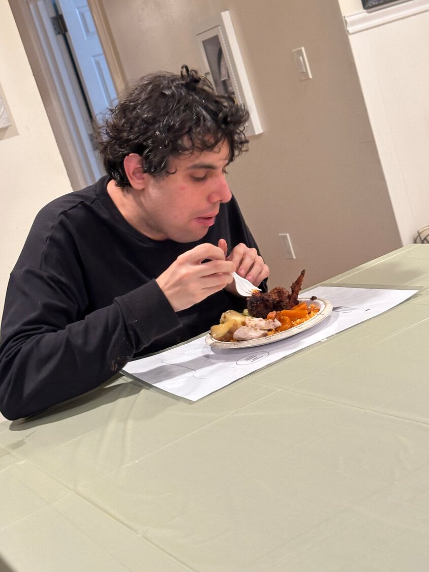 Gerald Asaro, a resident at Life’s WORC Islip Terrace group home, enjoyed a homemade Thanksgiving dinner that was prepared by staff with help from the residents.